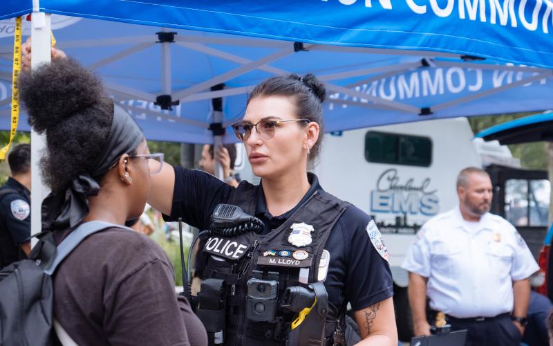 Transit Police officer interacts with a young lady at a community event.