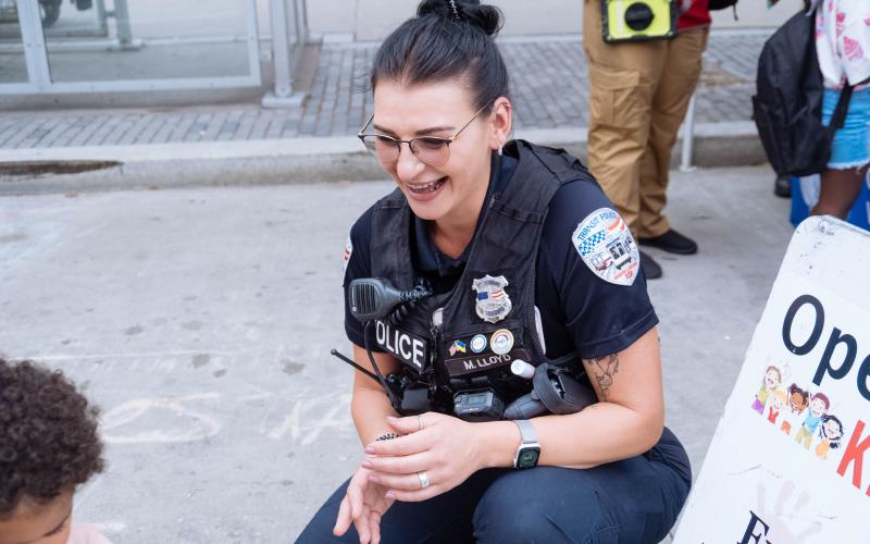 Transit Police officer interacts with a child at a community event.